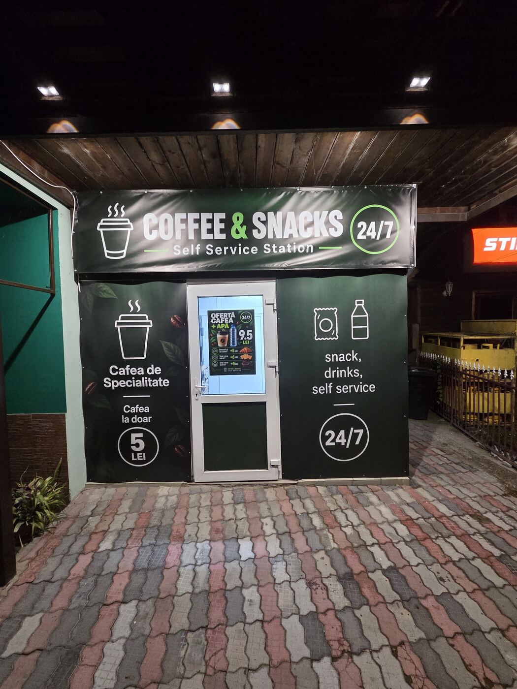 Fațada Coffee & Snacks Self Service Station noaptea